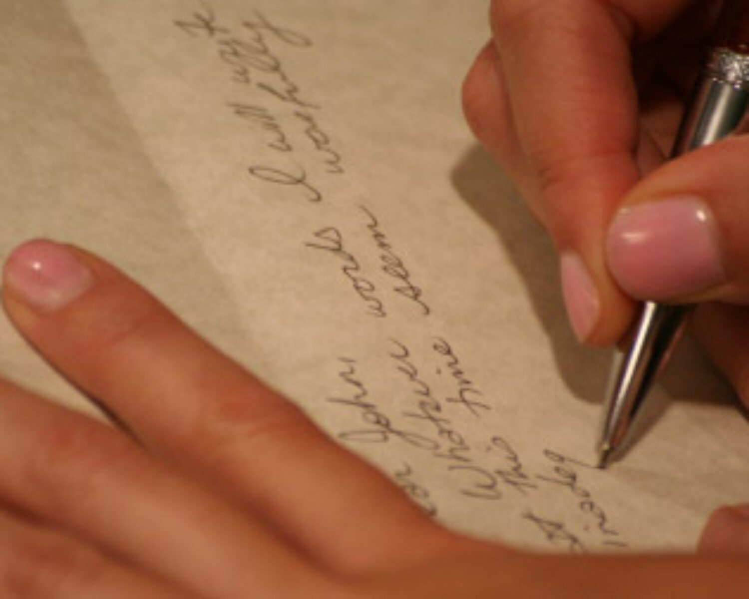 Close up of a woman writing a note.